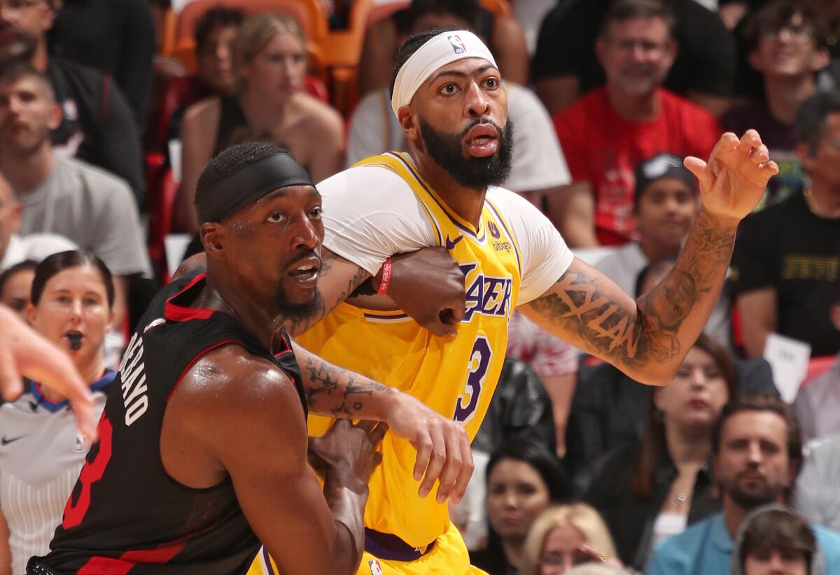 Lakers forward Anthony Davis, right, battles Miami Heat center Bam Adebayo for position.