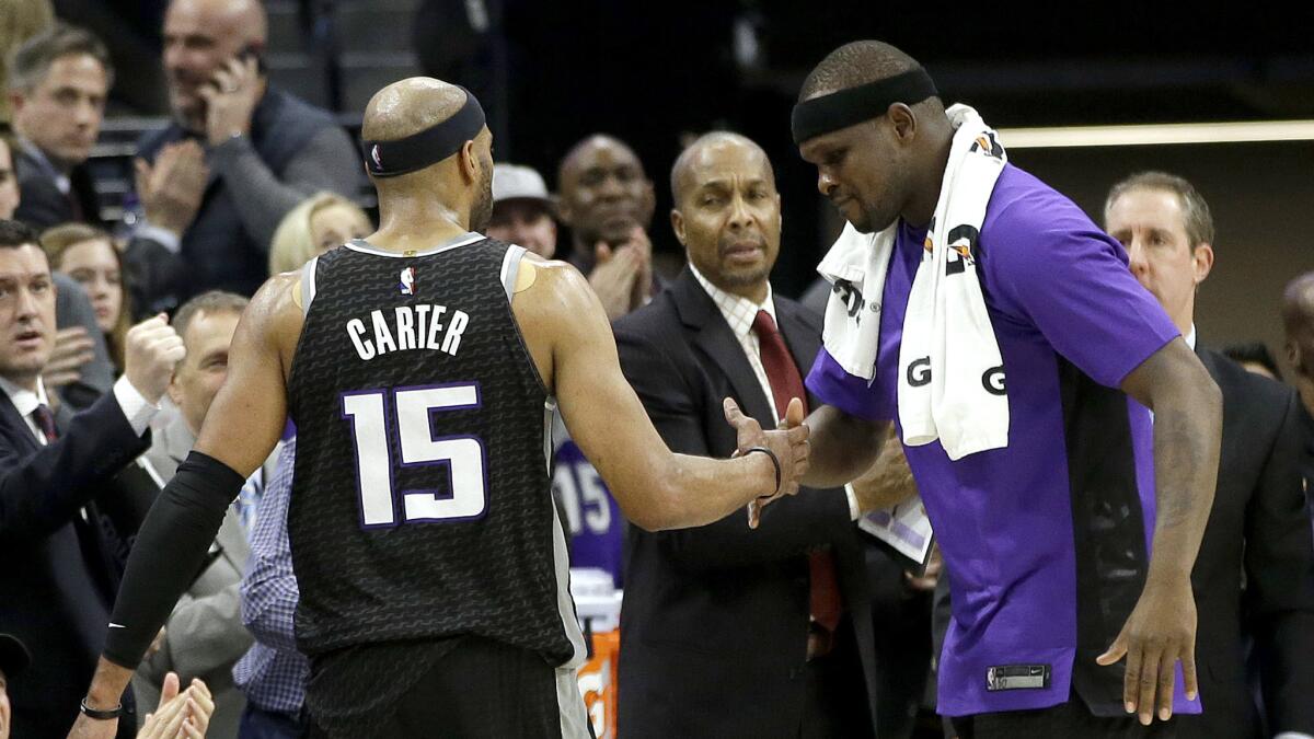 Kings guard Vince Carter is congratulated by teammate Zach Randolph while he walks off the court in the closing moments of a 109-95 defeat of the Cavaliers.