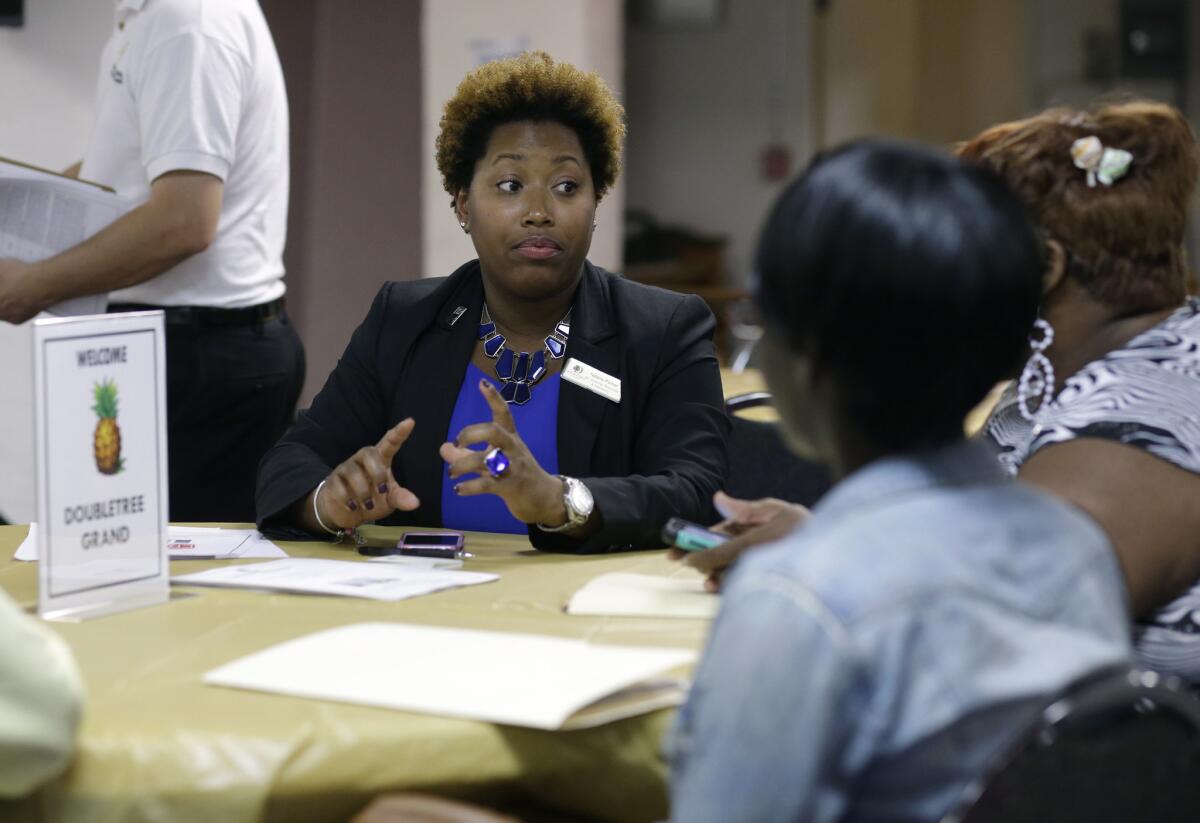Natalie Parker, director of human resources at the Doubletree Grand in Miami, left, talks with job applicants during a job fair at the Hospitality Institute on Jan. 23.