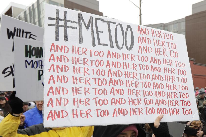 Protester carries a #MeToo sign