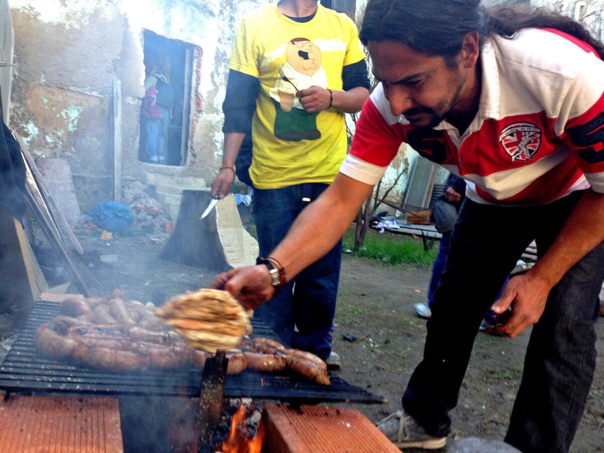 Graduates of a program to help drug addicts prepare a celebratory meal at a concrete church run by Father Carlos Olivero. "The parish is not a building; it's the neighborhood, it's the community," says Olivero, who moved to the slum in 2002. He says his first focus is on helping people, not converting them. But he believes faith is contagious.