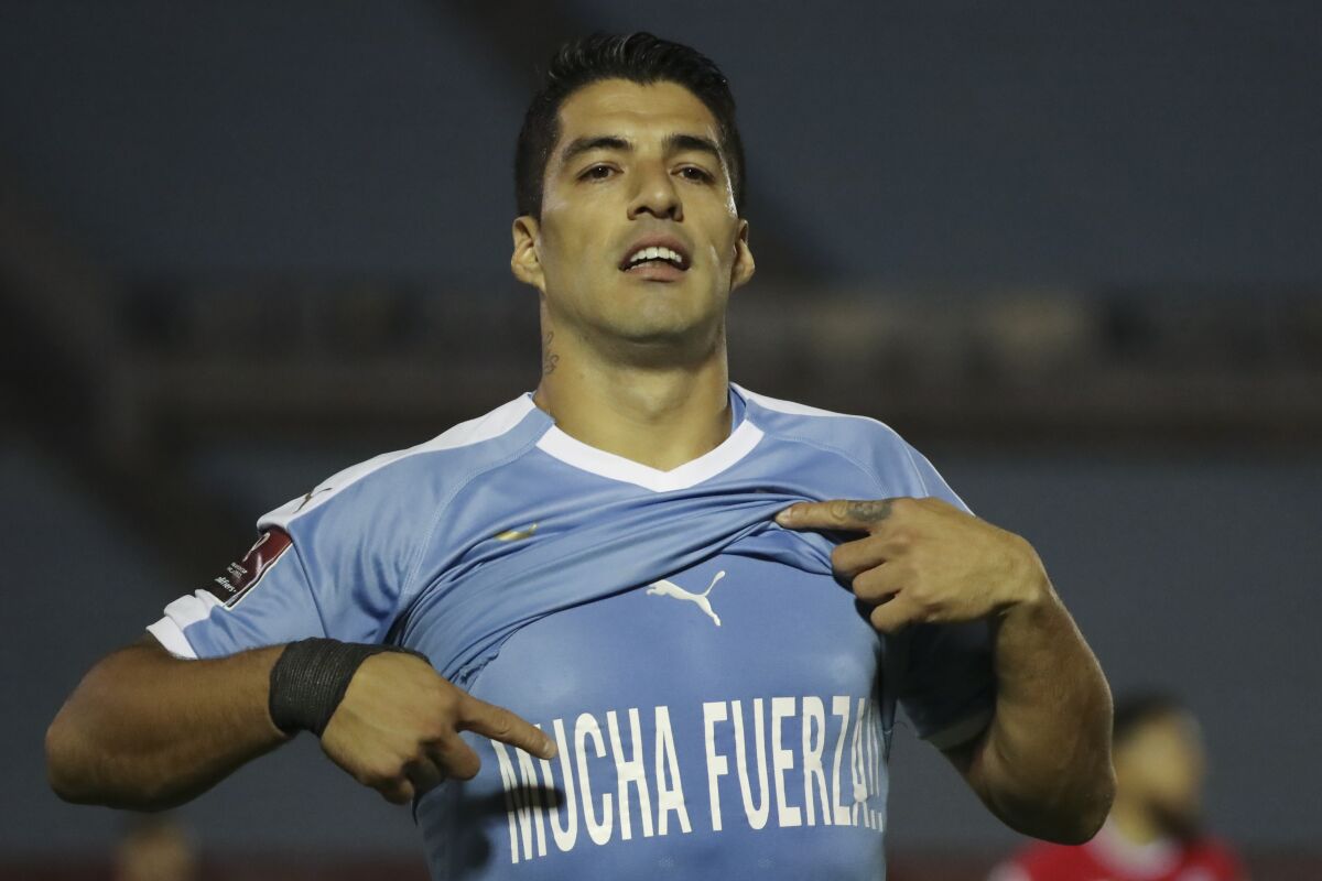 Uruguay's Luis Suarez celebrates scoring the opening goal against Chile during a qualifying soccer match for the FIFA World Cup Qatar 2022 at the Centenario stadium in Montevideo, Uruguay, Thursday, Oct. 8, 2020. (Raul Martinez/Pool via AP)