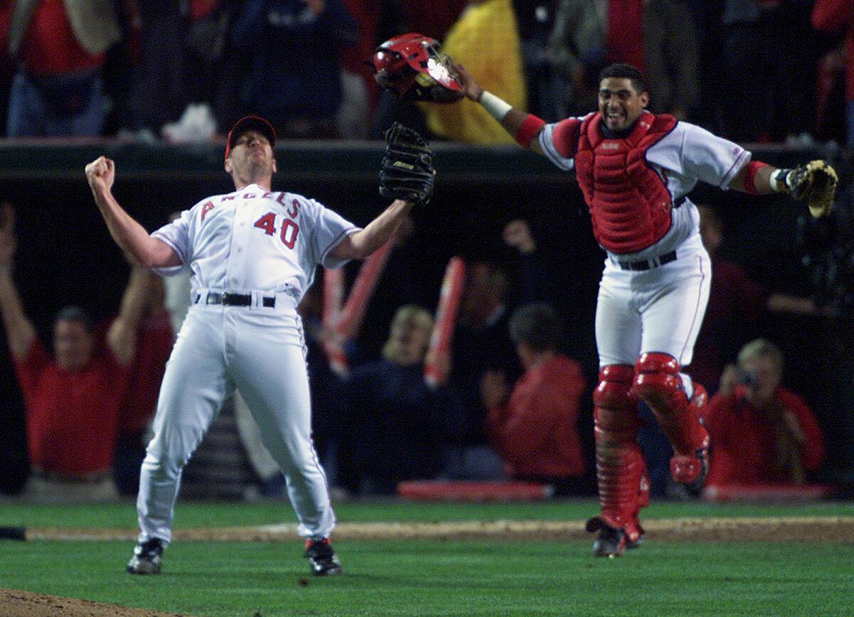Angels relief pitcher Troy Percival and catcher Bengie Molina celebrate the team’s 2002 World Series win over the Giants.