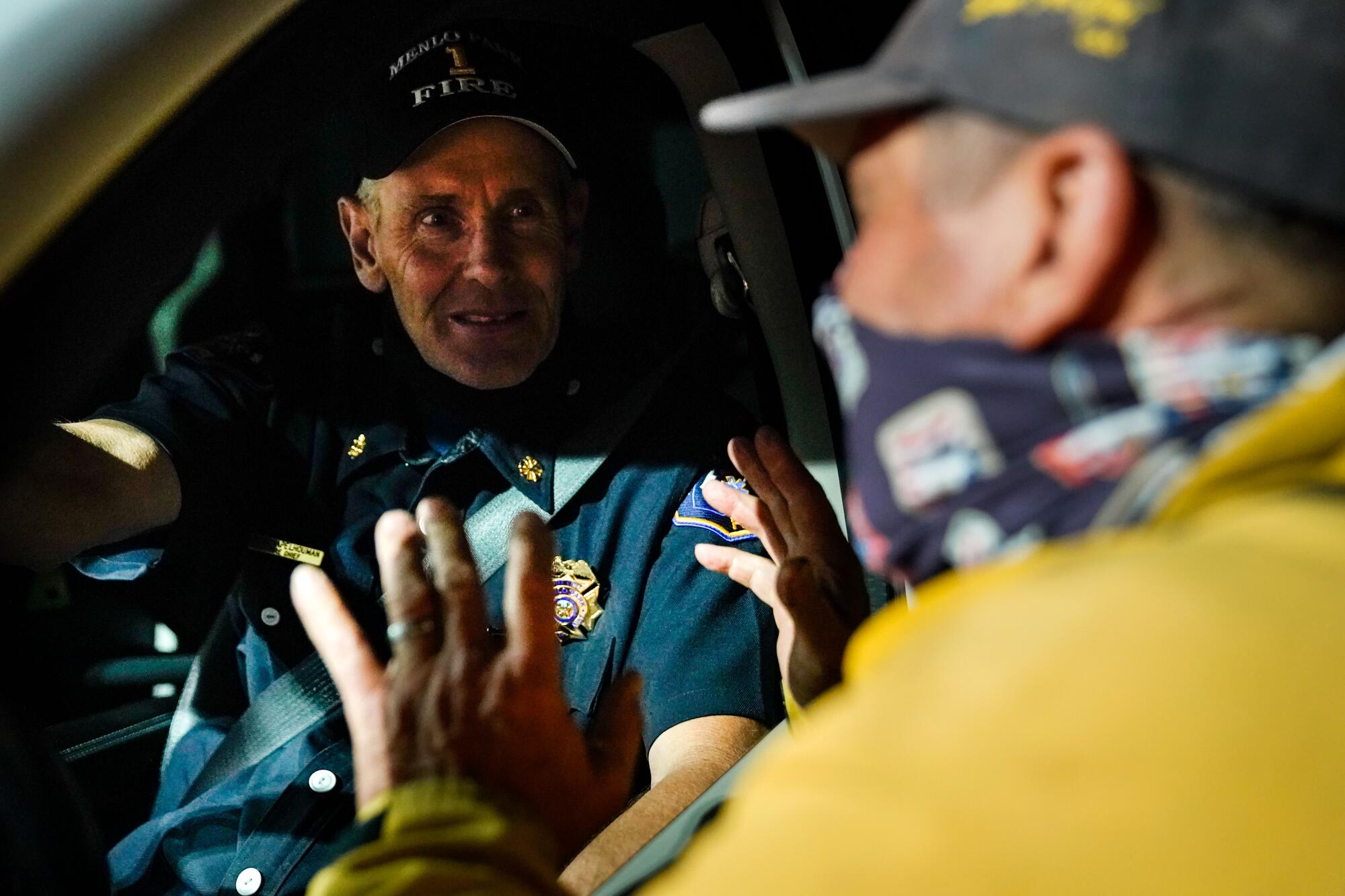 Menlo Park Fire Chief Harold Schapelhouman chats with Carl Kustin, a volunteer firefighter