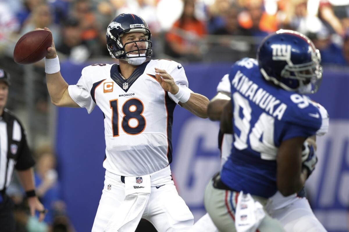 Peyton Manning throws a pass during the Denver Broncos' 41-23 victory over Eli Manning and the New York Giants on Sunday.