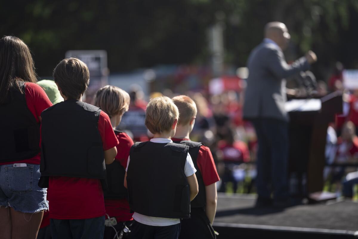 Students wearing body armor stand on a stage during a gun safety reform rally on Monday in Washington, DC. 