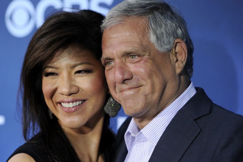 FILE - In this June 16, 2014 file photo, Les Moonves, right, president and CEO of CBS Corporation, and his wife Julie Chen pose together at the premiere of the CBS science fiction television series "Extant" in Los Angeles. Chen returned to television with an unusual sign-off days after her husband, Les Moonves, resigned as CBS CEO following sexual misconduct allegations. The 48-year-old ended Thursday, Sept. 13, 2018 Big Brother broadcast by saying, From outside the Big Brother house, Im Julie Chen Moonves. Good night. Usually, she just says Julie Chen. (Photo by Chris Pizzello/Invision/AP, File)