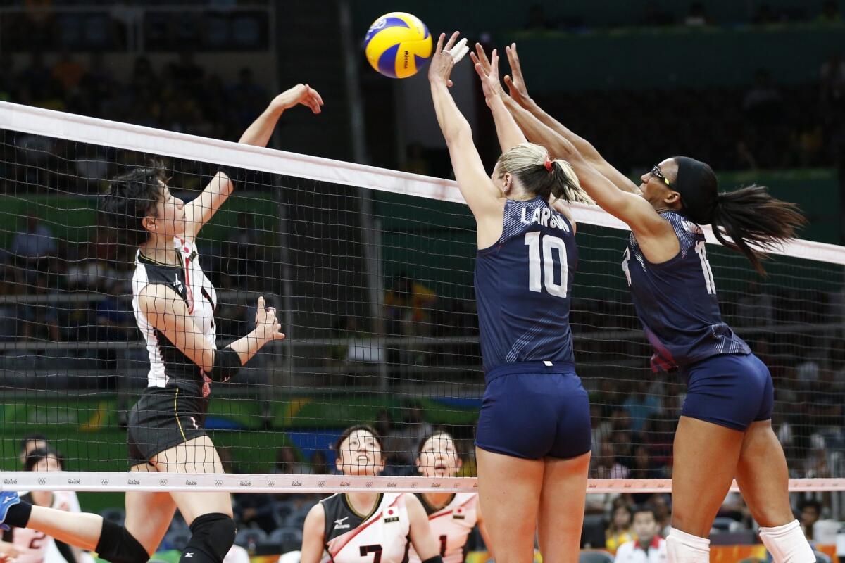 Americans Jordan Larson-Burbach (10) and Foluke Akinradewo attempt to block a spike by Japan's Nagaoka Miyu during a women's volleyball quarterfinal match on Tuesday.