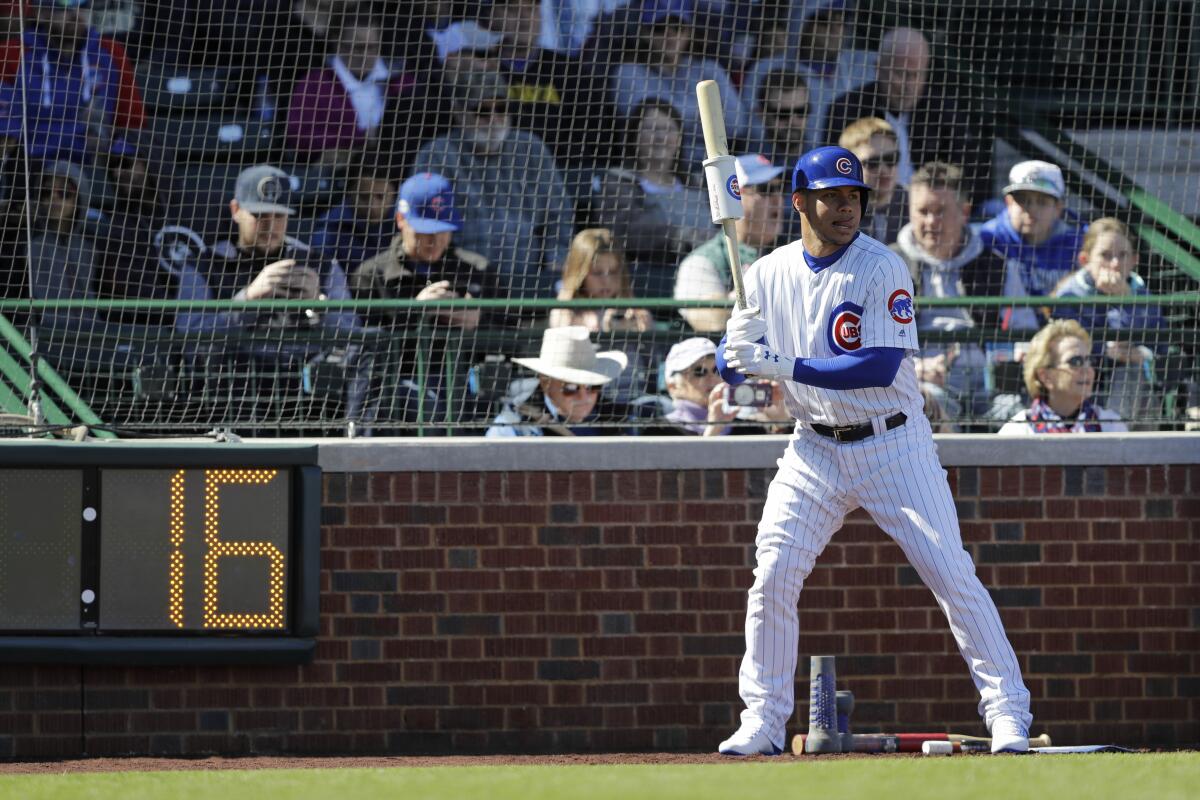 A pitch clock counts down while the Chicago Cubs' Willson Contreras waits on deck.