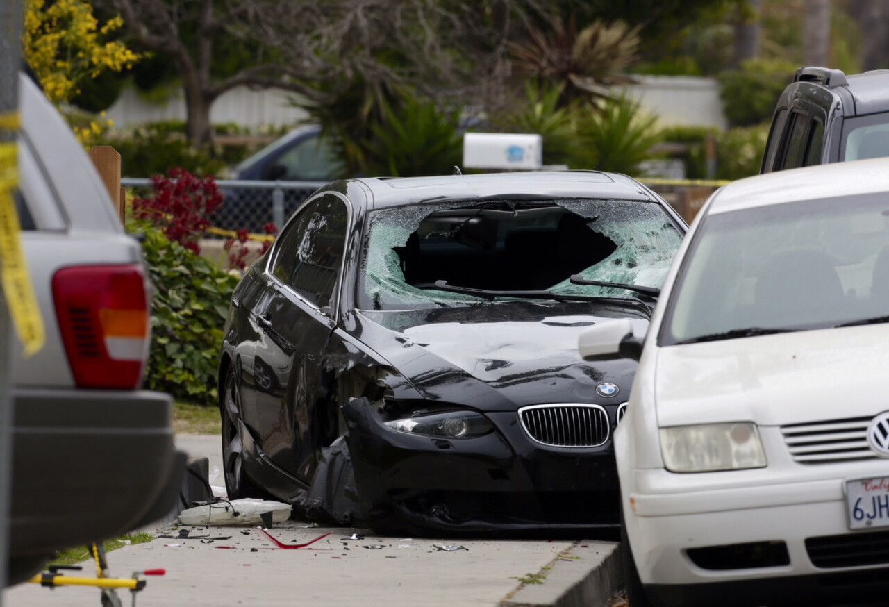 A black BMW with a shattered windshield is at the scene in Isla Vista.