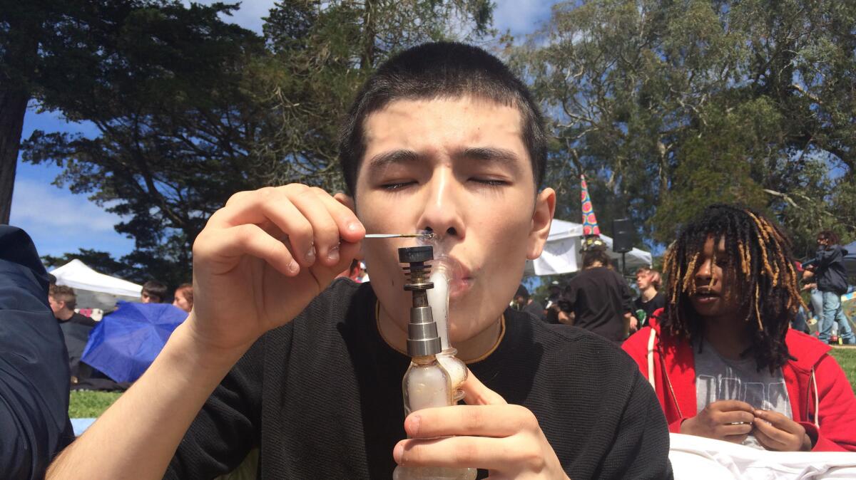 Sebastian Rosales smokes in Golden Gate Park in San Francisco on April 20 for the annual 4/20 celebration.