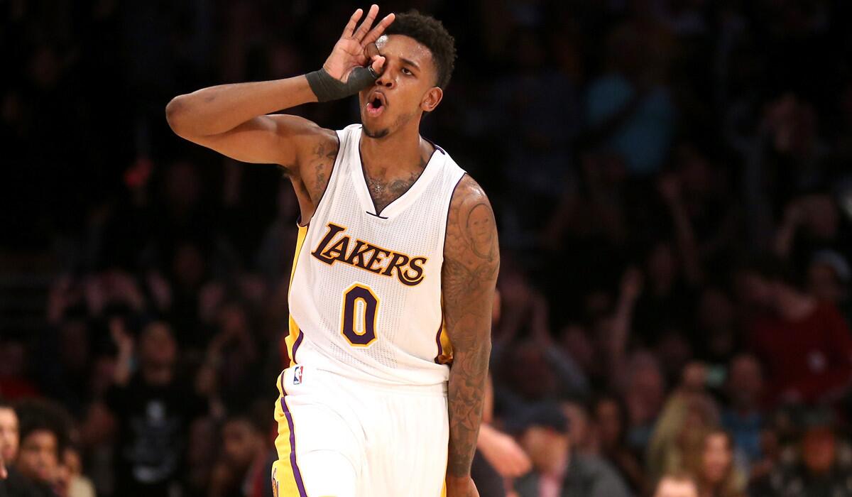 Lakers forward Nick Young celebrates after making a three-point shot against the Raptors late in the second half.