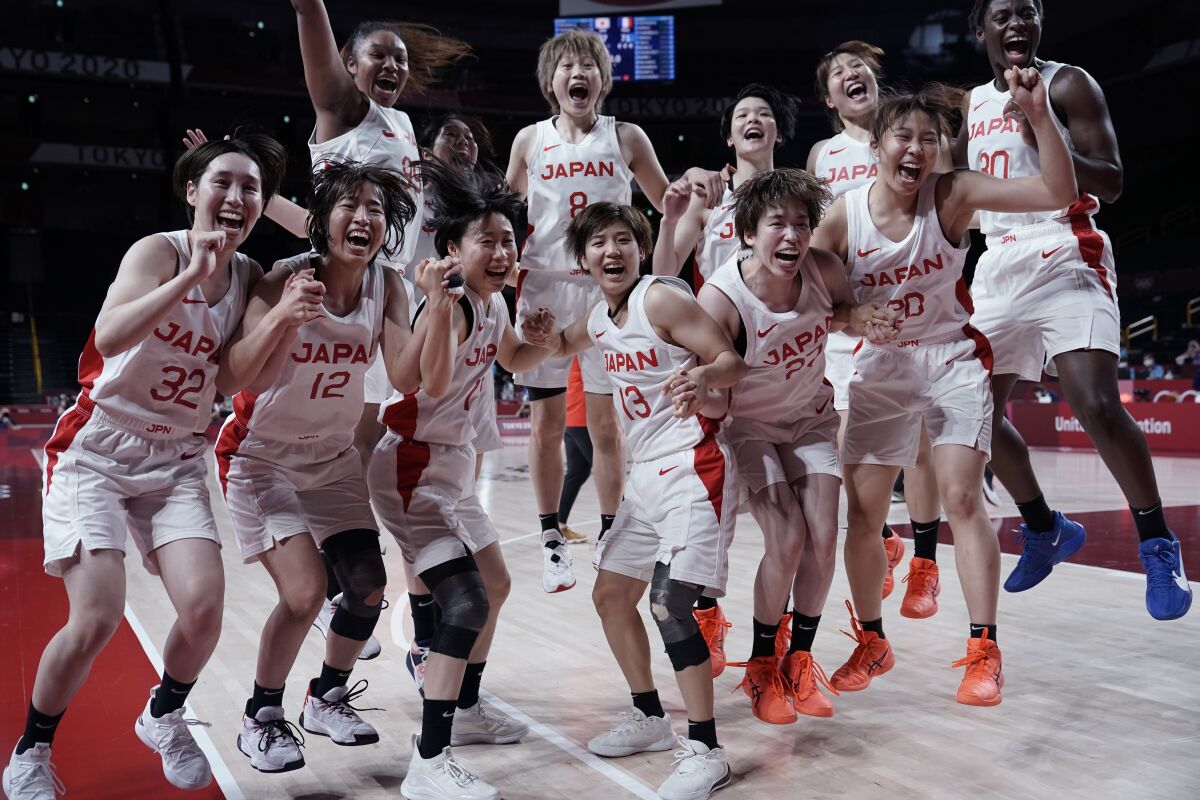 Japan players celebrate their win over France in a women's semifinal basketball game at the 2020 Summer Olympics, Friday, Aug. 6, 2021, in Saitama, Japan. (AP Photo/Eric Gay)