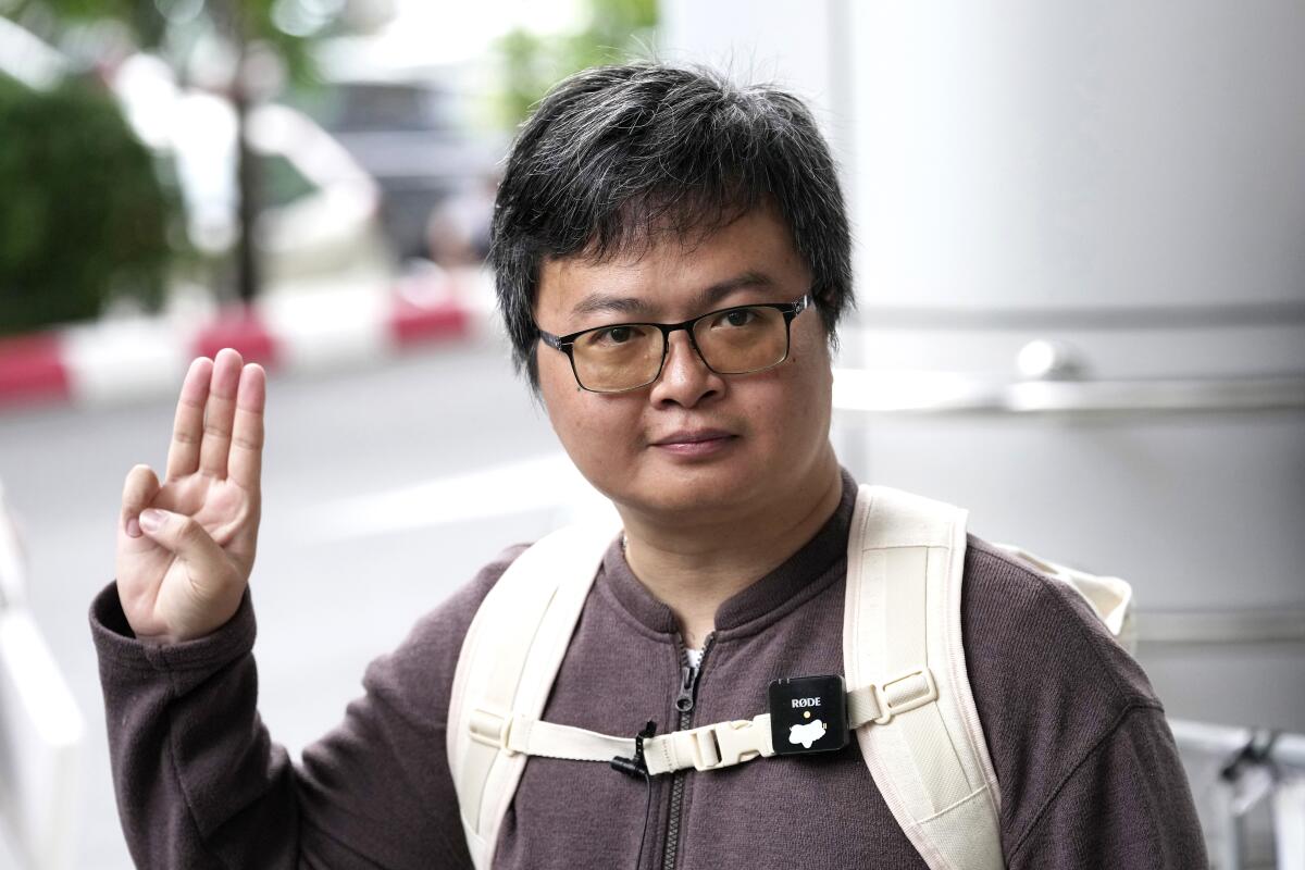 Thai human rights lawyer flashing  three-fingered resistance salute