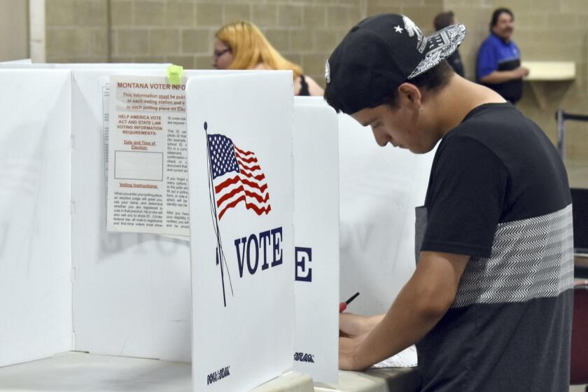Devin Asbell fills out his primary election ballot fills out his ballot at MetraPark Arena in Billings, Mont., Tuesday, June 5, 2018. Turnout was light at polling places in Montana's largest city as most voters already had cast their primary ballots by mail. (AP Photo/Matthew Brown)