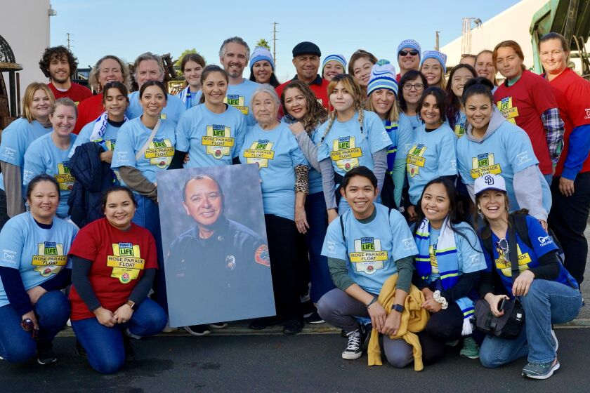 Group photo of staff members from Lifesharing and UC San Diego Health, joined by the family of San Diego Fire-Rescue Capt. Robin Cervantes. Photo was taken on December 3, 2022, at Fiesta Parade Floats in Irwindale, CA.