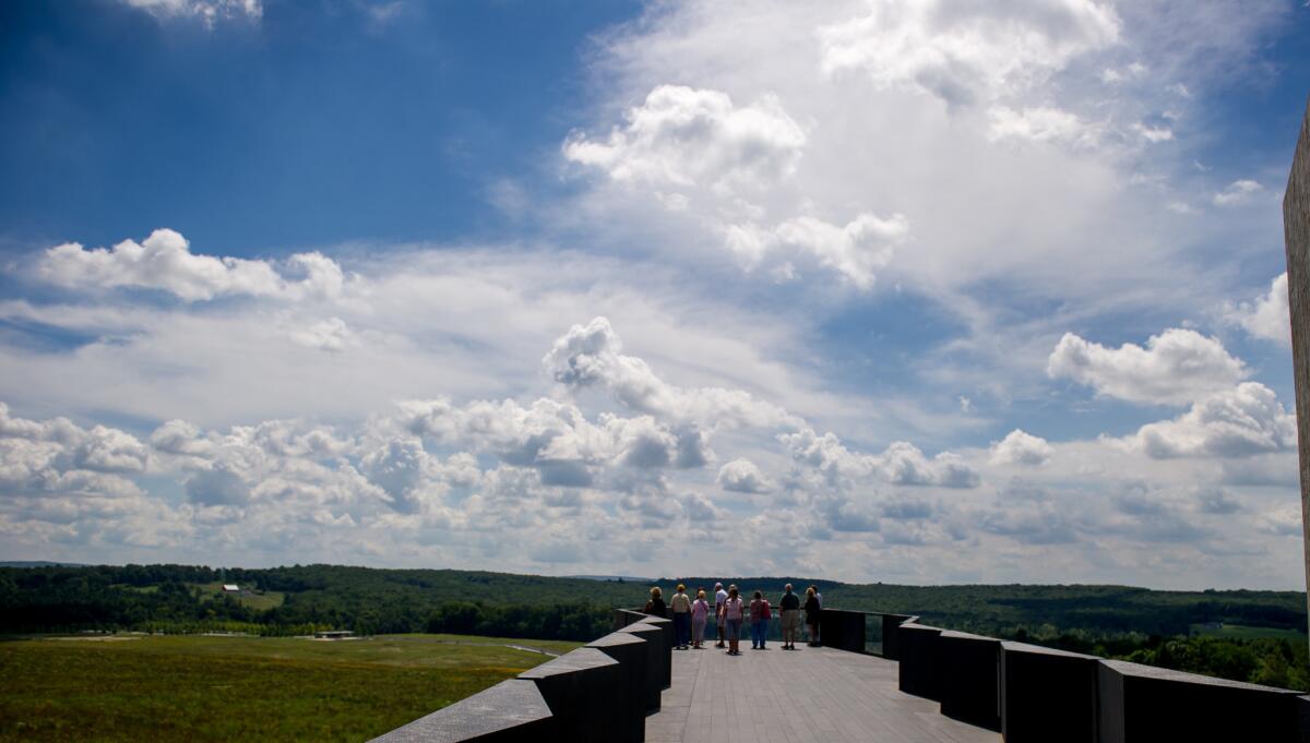 Visitors at the Flight 93 National Memorial look over the flight path of the plane that crashed on Sept. 11, 2001.