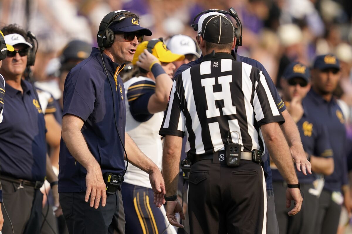 California head coach Justin Wilcox, left, speaks to an official during the second half of an NCAA college football game against TCU in Fort Worth, Texas, Saturday, Sept. 11, 2021. (AP Photo/Tony Gutierrez)