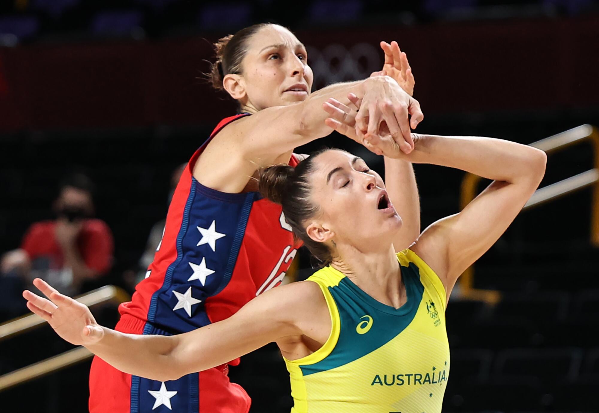 Australian Katie Ebzery fouls Diana Taurasi during the women's basketball quarterfinal at the Tokyo Olympics. 