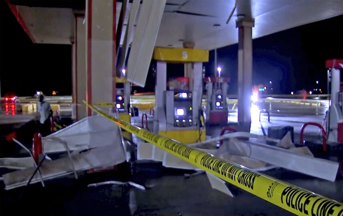 In this image made from video, debris from tornadoes pile around the pumps of a filling station late Sunday, Oct. 10, 2021, in Shawnee, Oklahoma. Several reported tornadoes ripped through Oklahoma late Sunday into early Monday morning, causing damage but no immediate word of deaths or injuries. (KWTV via AP)