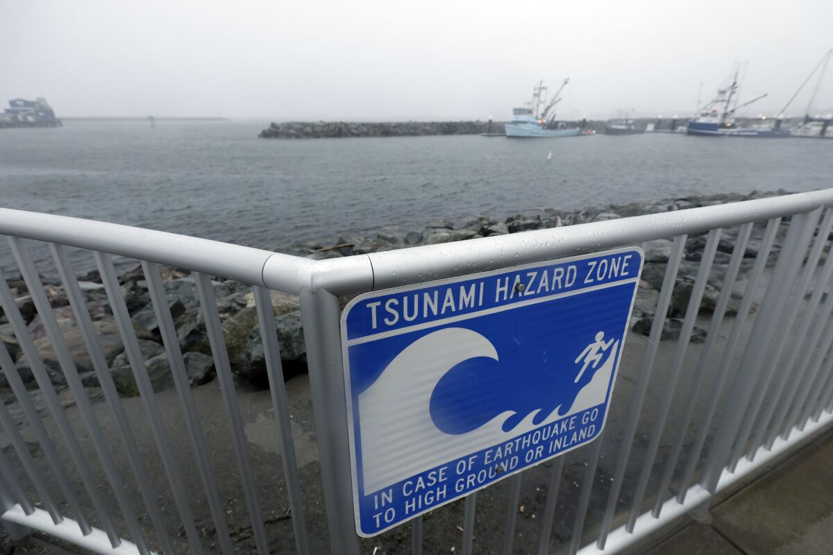 A sign warns of a tsunami hazard zone at the coast in Crescent City