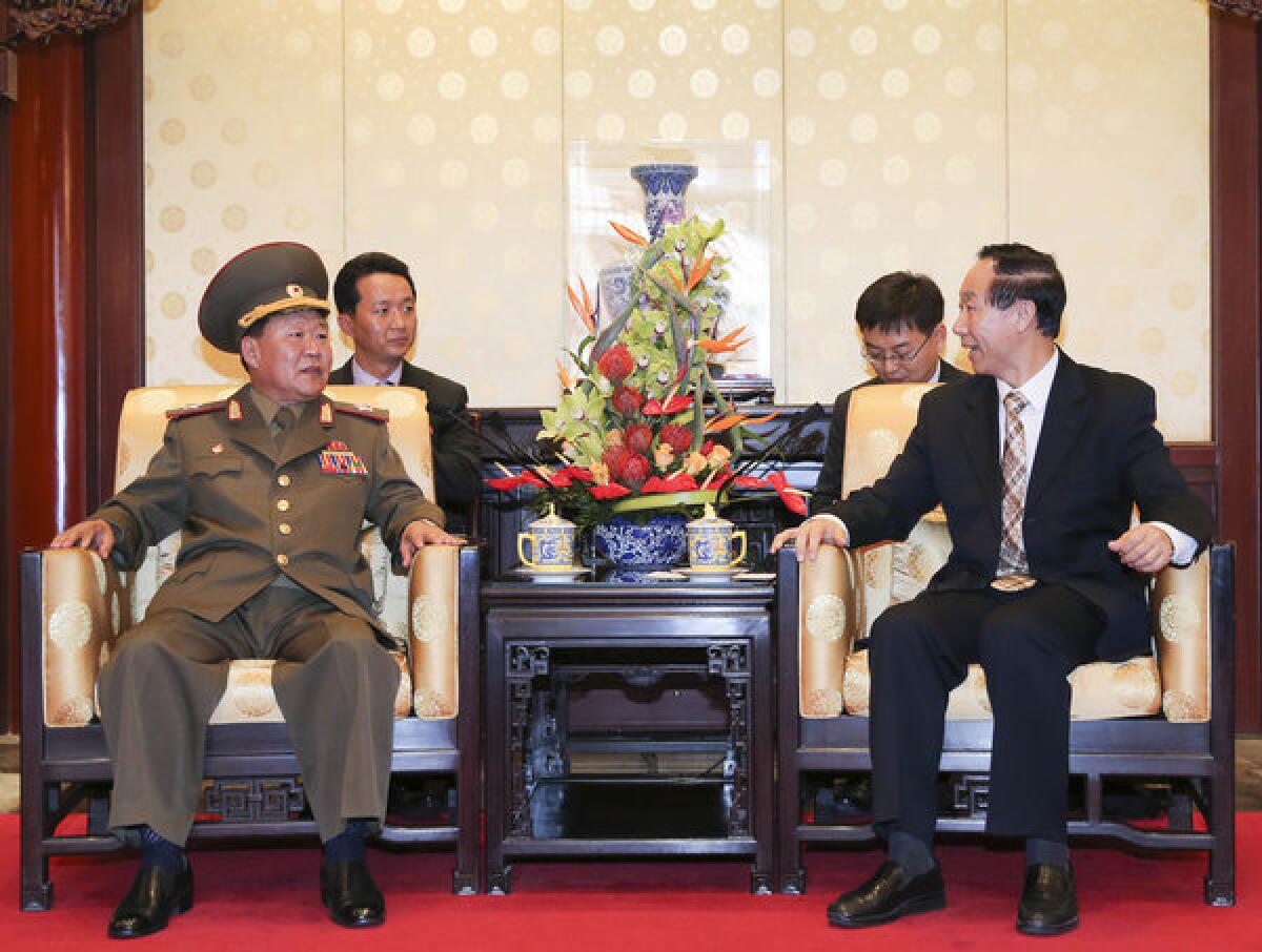 In this image provided by China's official Xinhua News Agency, Wang Jiarui, right, the head of the Chinese leadership's international affairs office, meets with North Korea's Vice Marshal Choe Ryong Hae in Beijing.