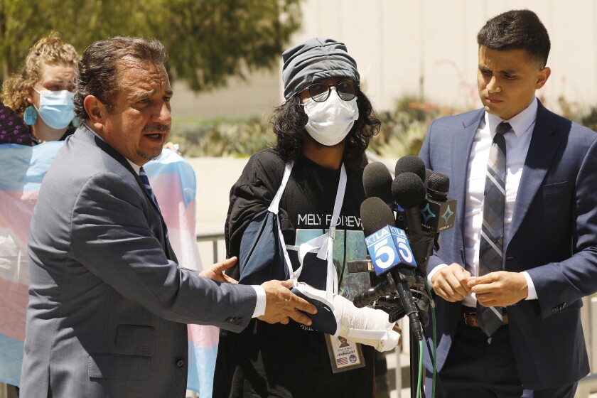 Attorneys Humberto Guizar, left, and Christian Contreras, right, with Vishal Singh, center