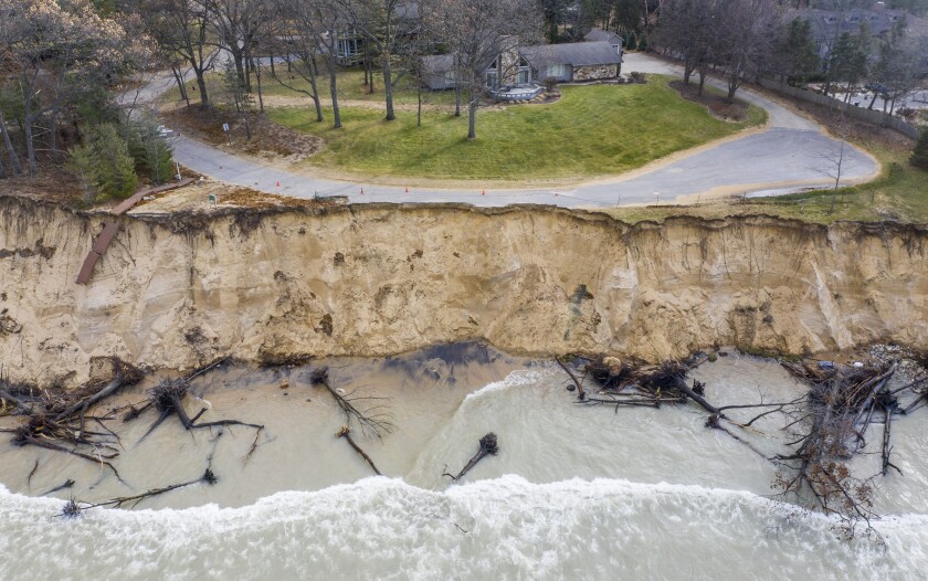 FILE - In this Dec. 4, 2019 file photo, widespread Lake Michigan shoreline erosion reaches Dune Lane and approaches homes in Stevensville, Mich. A months-long spell of dry, mild weather is giving the Great Lakes a break after two years of high water that shattered records and heavily damaged shoreline roads and homes, officials said Monday May 10, 2021. (Robert Franklin/South Bend Tribune via AP. File)
