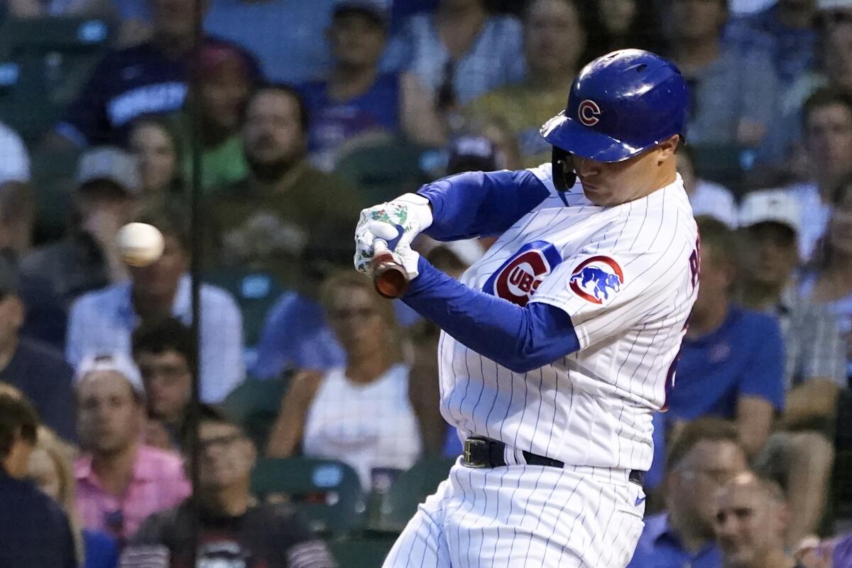 Chicago Cubs' Joc Pederson hits an RBI double off Philadelphia Phillies starting pitcher Aaron Nola during the third inning of a baseball game Tuesday, July 6, 2021, in Chicago. Sergio Alcantara scored on the play. (AP Photo/Charles Rex Arbogast)