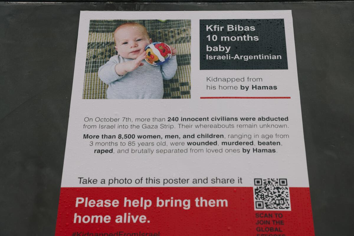 An image from the display shows a baby and the words "please help bring them home alive."