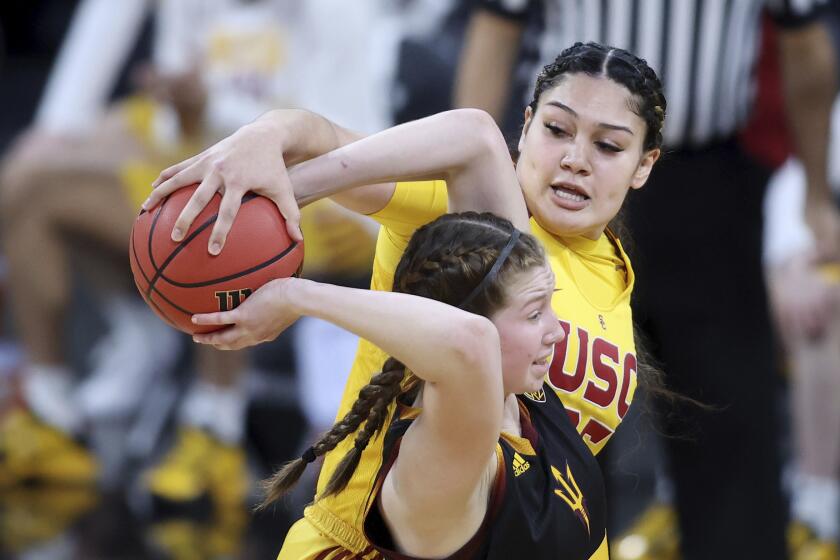 Southern California forward Alissa Pili (35) steals the ball from Arizona State guard Maggie Besselink (13) during an NCAA college basketball game in the first round of the Pac-12 women's tournament Wednesday, March 3, 2021, in Las Vegas. (AP Photo/Isaac Brekken)