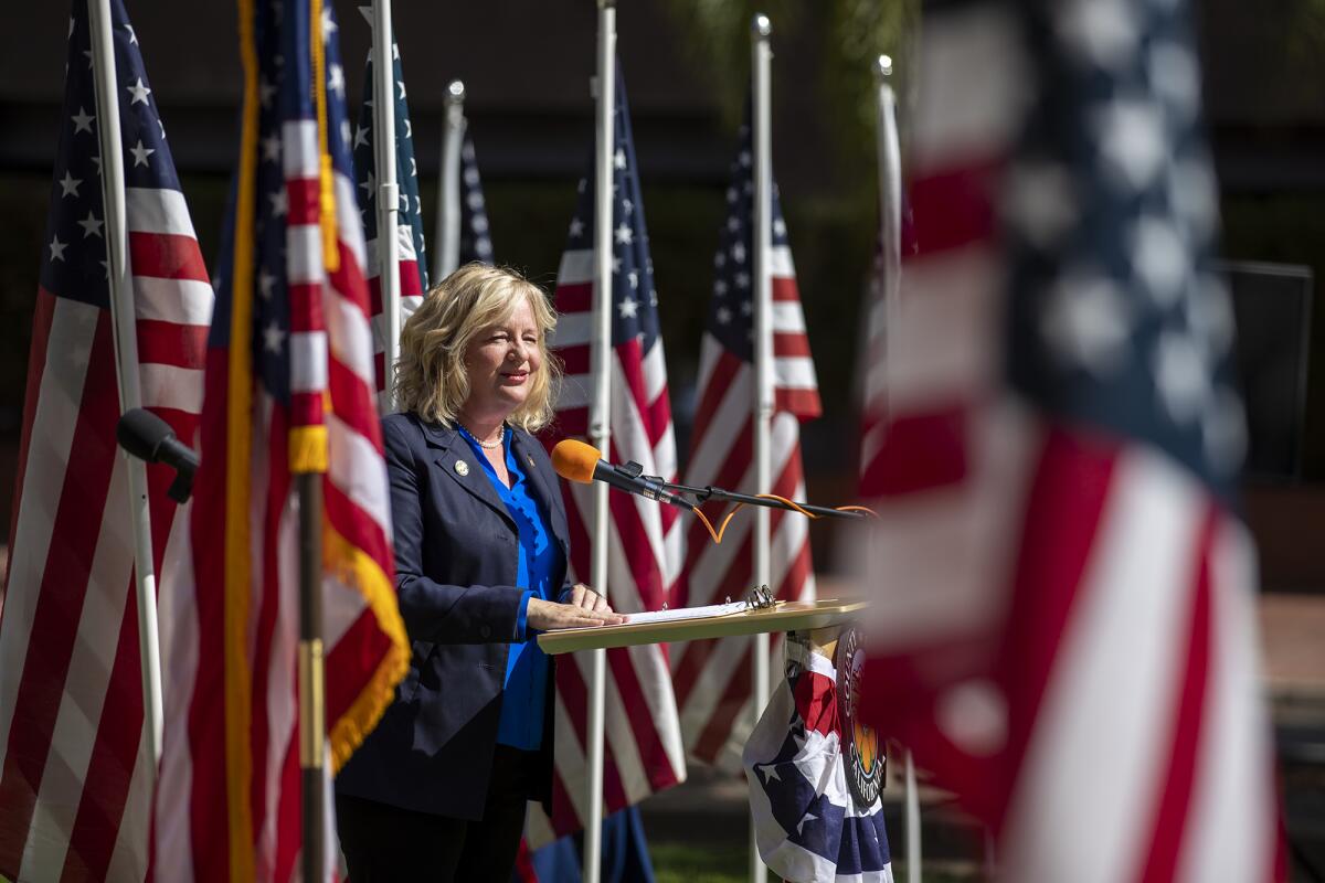 O.C. Supervisor Katrina Foley speaks during a Flag Day event surrounded by American flags