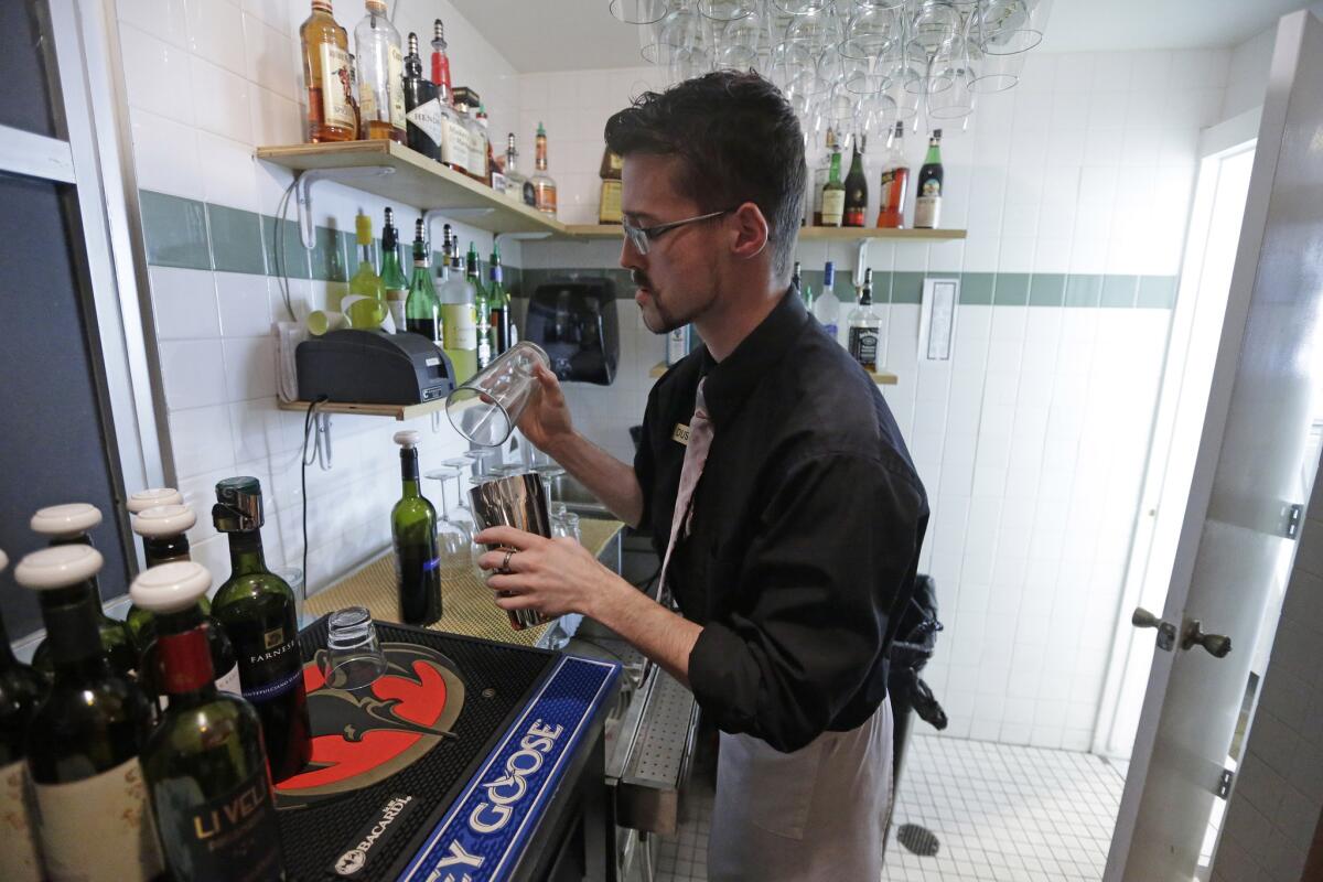 Dustin Humes fixes a drink in a small room that's out of view of patrons at Vivace Restaurant in Salt Lake City.