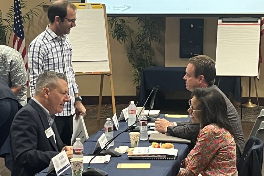 Huntington Beach City Manager Al Zelinka, bottom left, and City Council members Dan Kalmick, Casey McKeon and Rhonda Bolton, clockwise, participate in an ice breaker exercise at Thursday's strategic planning workshop.
