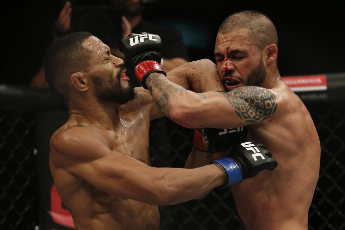 Deiveson Figueiredo, left, and Marco Beltran throw blows during their bantamweight bout at UFC 212.