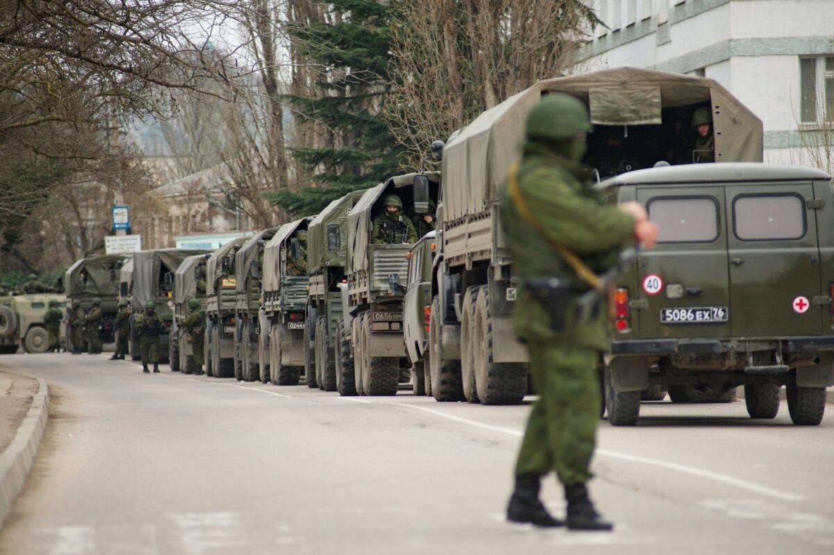 Armed men, described by Interior Minister Arsen Avakov as Russian naval forces, block a Ukrainian military base in Balaklava, in the Crimean peninsula of Ukraine, on Saturday. The troops also took control Friday of the airports in Simferopol and near the port of Sevastapol where the Russian Black Sea fleet has a base.
