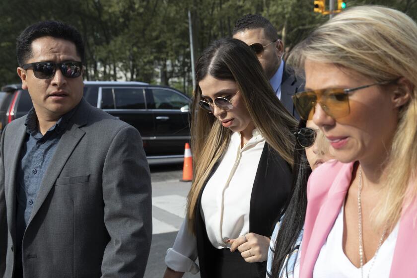 FILE - In this July 17, 2019 file photo, Emma Coronel Aispuro, center, wife of Mexican drug lord Joaquin "El Chapo" Guzman, arrives for his sentencing at Brooklyn federal court, in New York. According to the United States Department of Justice, Coronel has been arrested on Monday, Feb. 22, 2021, under drug trafficking charges. (AP Photo/Mark Lennihan, File)