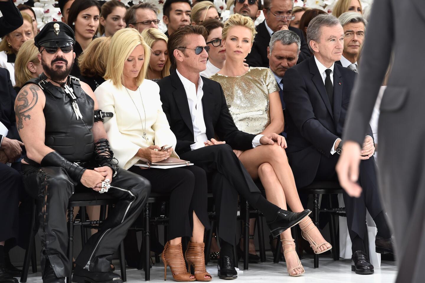 Leather-clad architect Peter Marino, left; Marie-Chantal, crown princess of Greece; actors Sean Penn and Charlize Theron; and LVMH Chairman and Chief Executive Bernard Arnault attend the Christian Dior show.