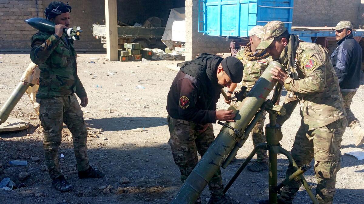 Iraqi troops in east Mosul prepare mortar equipment for their assault on the western part of the city, where Islamic State militants are entrenched.