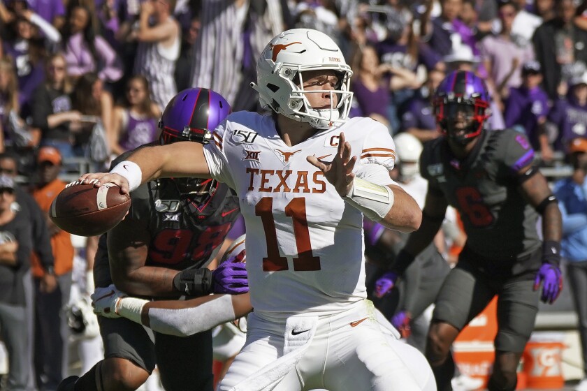 Texas quarterback Sam Ehlinger (11) throws a pass in the first half of an NCAA college football game against TCU in Fort Worth, Texas, Saturday, Oct. 26, 2019. (AP Photo/Louis DeLuca)