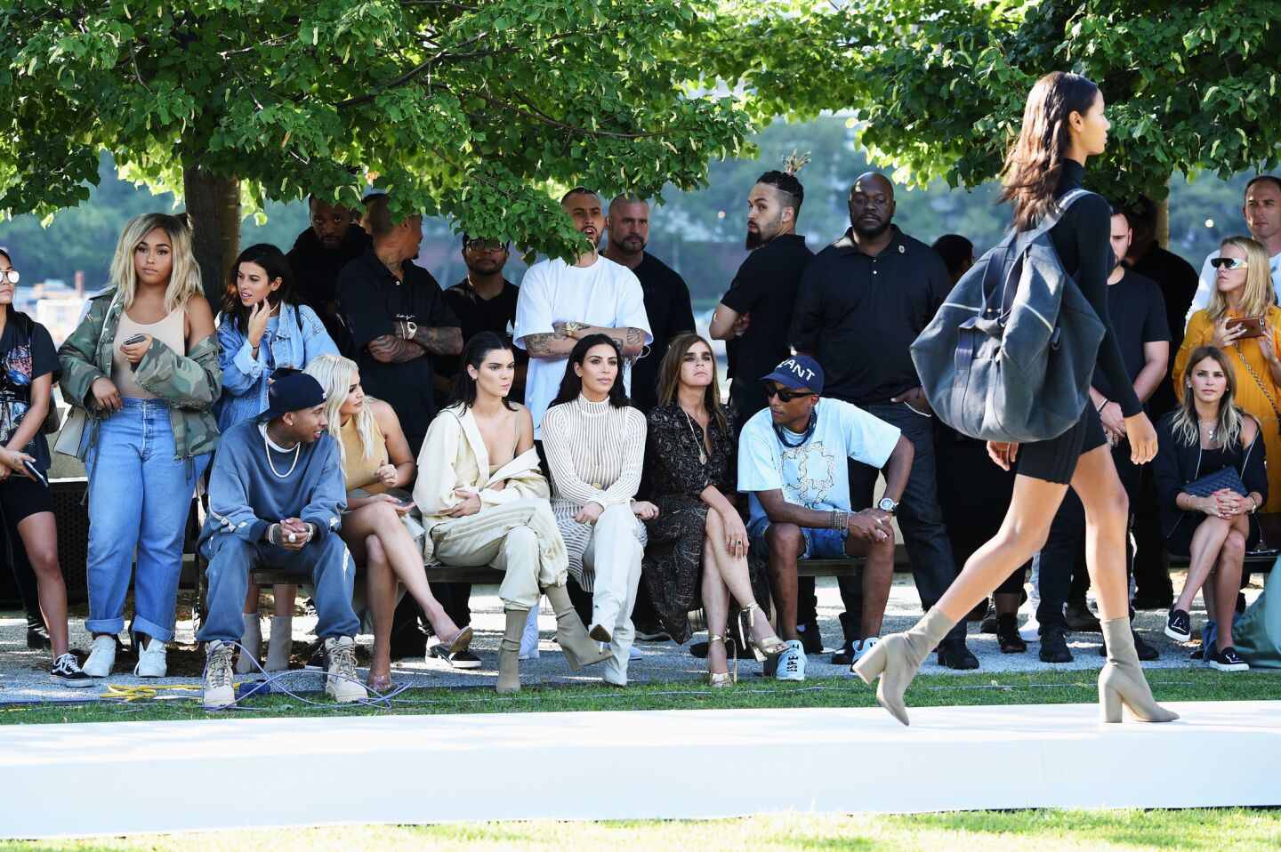 Tyga, seated front left, Kylie Jenner, Kendall Jenner, Kim Kardashian, Carine Roitfeld and Pharrell Williams attend the Kanye West Yeezy Season 4 fashion show.