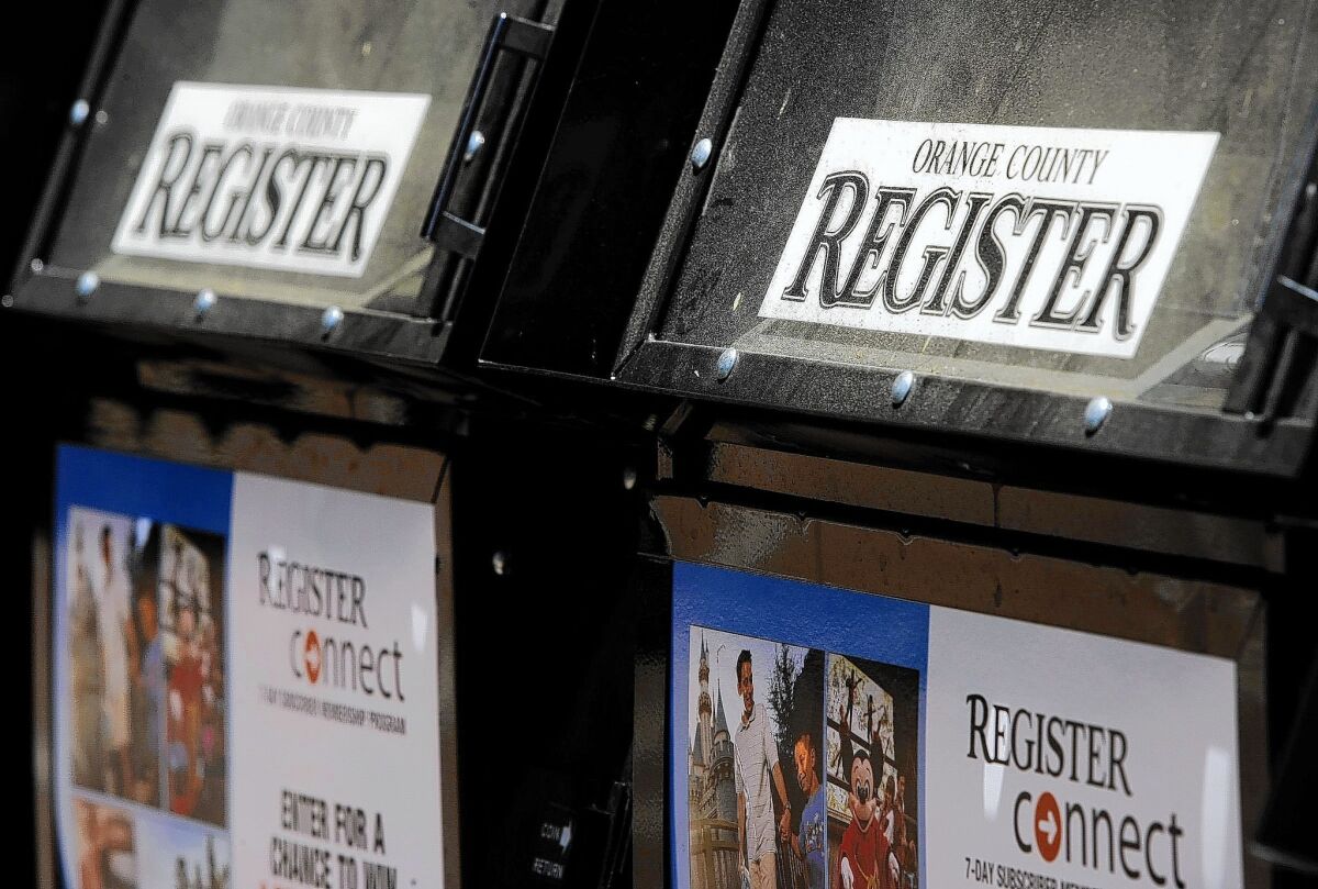Newspaper boxes outside the Orange County Register in Santa Ana. A $45.5-million bid from Digital First Media for the assets of parent Freedom Communications will be the "stalking horse" bid in an auction Wednesday.
