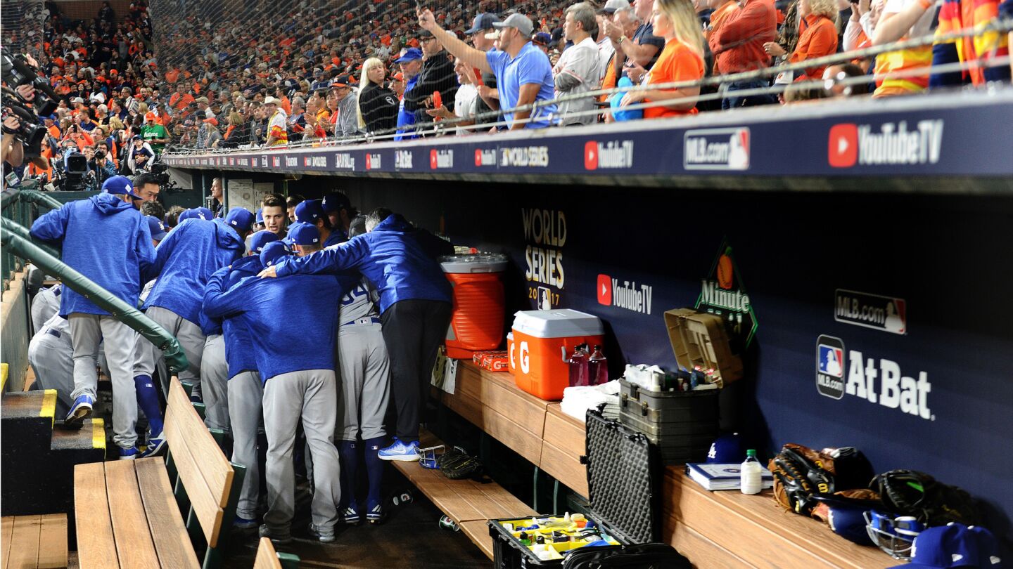 Dodger players huddle in the dugout before Game 4.