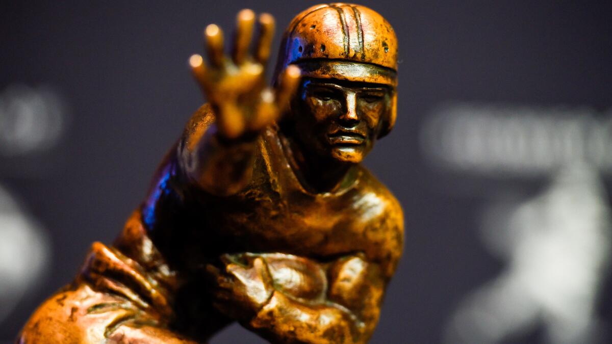 The Heisman Trophy awarded to Oregon's Marcus Mariota is on display at the New York Marriott Marquis hotel on Saturday.