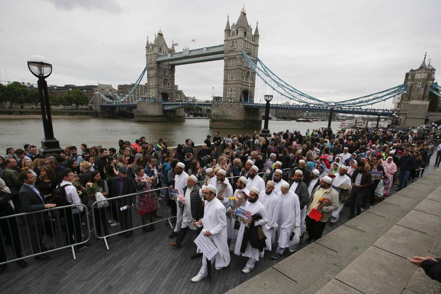 Members of the Dawoodi Bohra Muslim community join others at a vigil at Potters Fields Park in London on Monday to commemorate the victims of the terror attack on London Bridge and at Borough Market.
