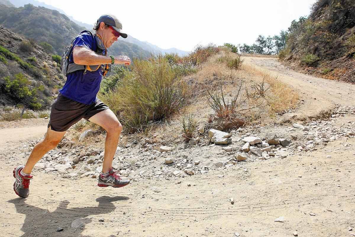 Burbank resident Roy Wiegand running up a dirt trail