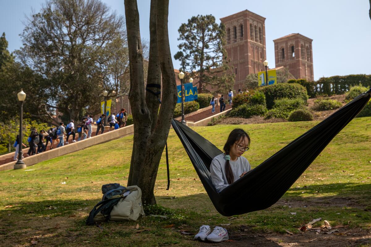 Engkanchanith Tan, an electrical engineering student, relaxes in a hammock under shade of a tree at UCLA.