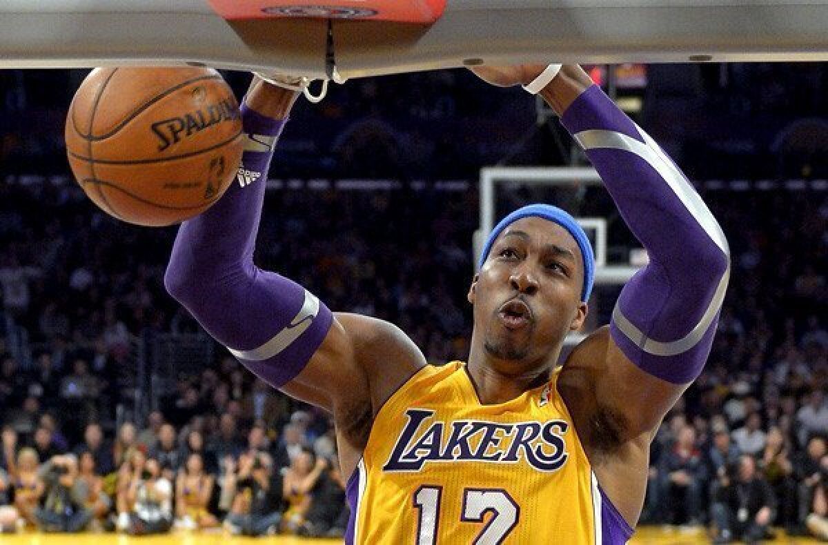 Lakers center Dwight Howard dunks against the Jazz on Friday night, when he had 17 points on eight-for-12 shooting and took 13 rebounds.