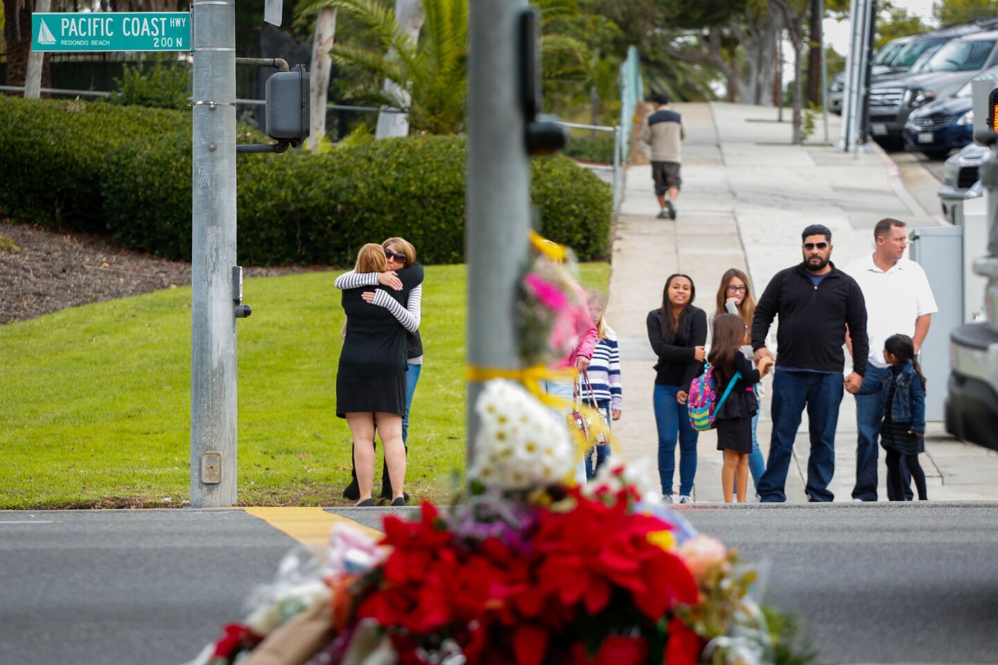 People dropped flowers and stopped at the corner of Vincent Street and Pacific Coast Highway in Redondo Beach near the site of the fatal accident.