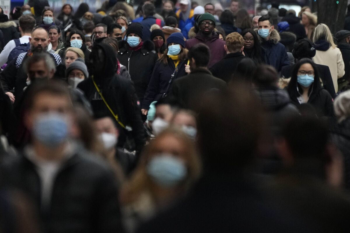 Shoppers in masks on a busy London street.